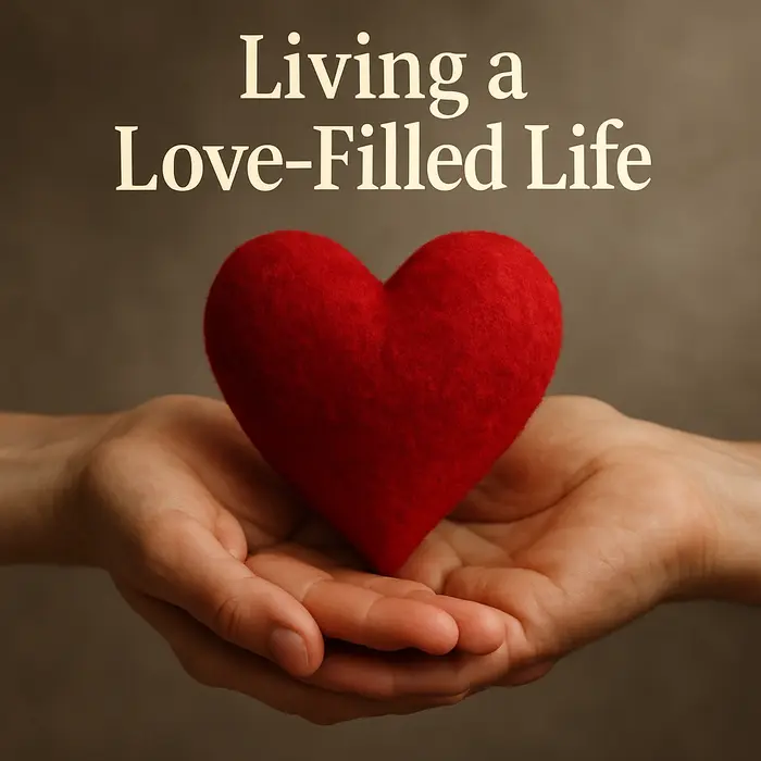 Plush red heart held in hands with “Living a Love-Filled Life” text above